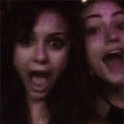two women are posing for a picture and one has her mouth wide open