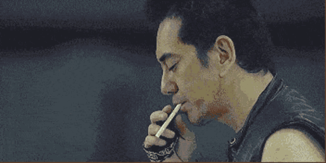 a pixelated image of a man smoking a cigarette with the word jack daniels visible