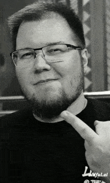 a man wearing glasses and a black shirt with the word faithful on the front
