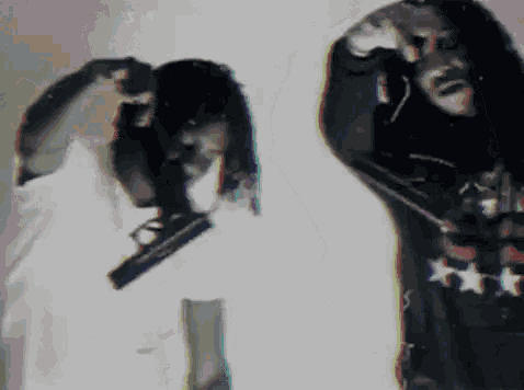 a blurry photo of a man holding a gun and a woman holding a gun
