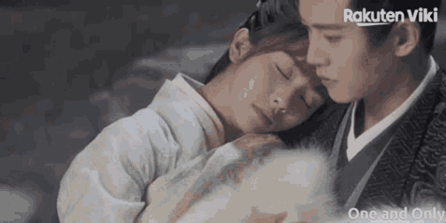 a man and a woman are hugging each other with rakuten viki written on the bottom right