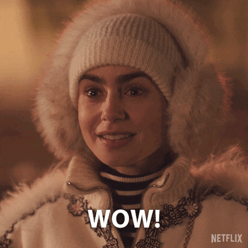 a woman wearing a white hat and a white coat with the word wow on it