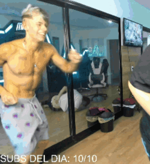 a shirtless man is standing in front of a mirror with the words subs del dia written below him