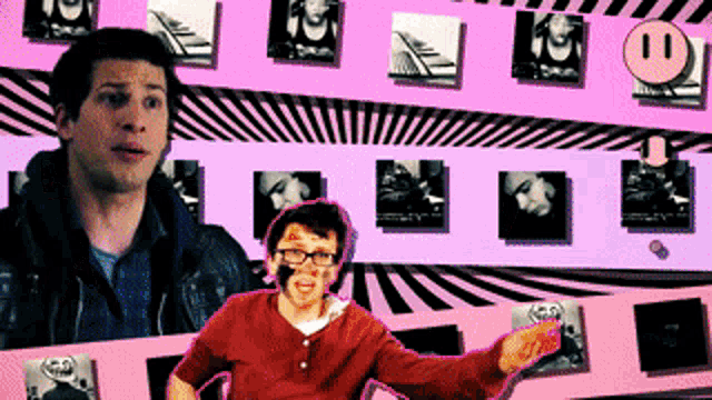 a man in a red shirt is standing in front of a pink wall