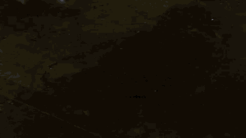 a close up of a person 's shadow on a dark surface .