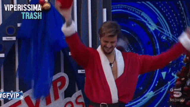 a man in a santa suit is clapping in front of a sign that says " vip lines "