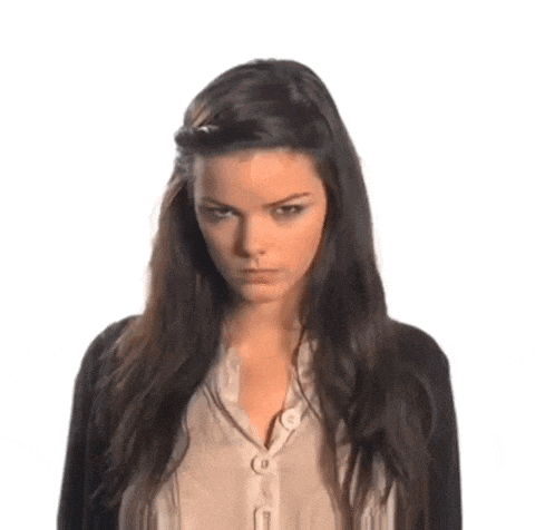 a woman with long dark hair is wearing a black cardigan and a beige shirt .