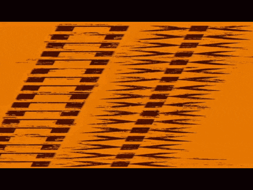 a yellow background with a black pattern that looks like a tire track