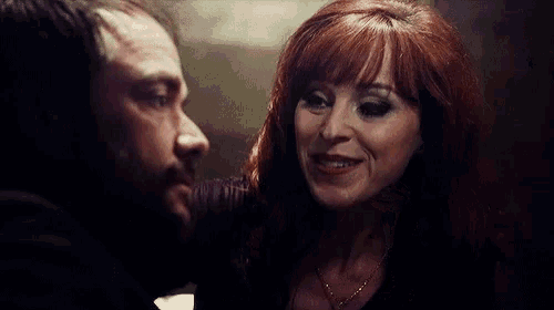 a man and a woman are touching each other 's faces .