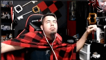 a man wearing headphones and a plaid shirt is sitting in front of a dxr chair