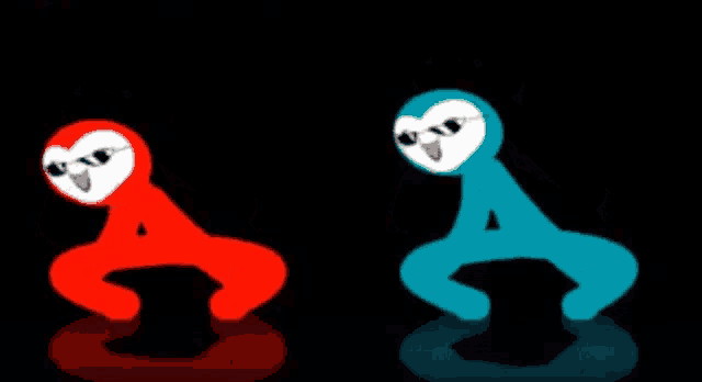 a red owl and a blue owl are sitting next to each other on a black surface