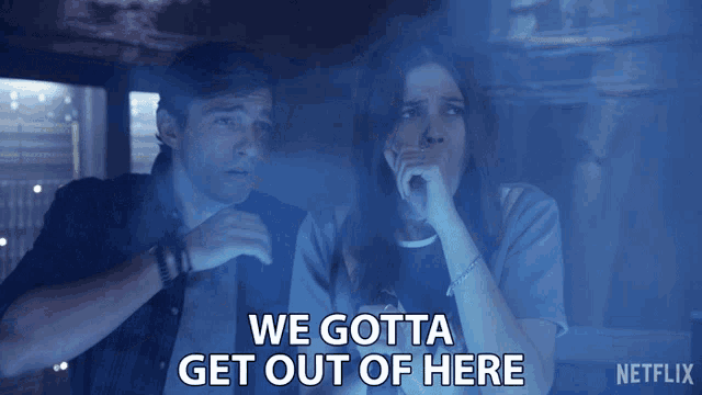 a man and a woman are sitting in a dark room with the words " we gotta get out of here " above them