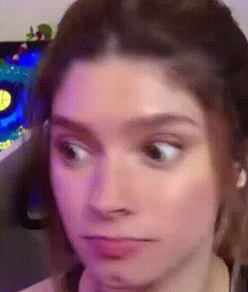 a woman is making a funny face with her eyes closed .