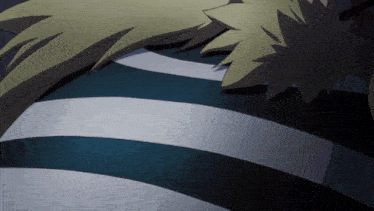 a close up of a person 's back with a blue and white striped shirt