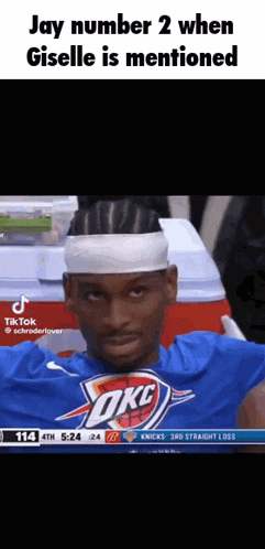 a basketball player wearing a headband and a blue shirt with the word okc on it