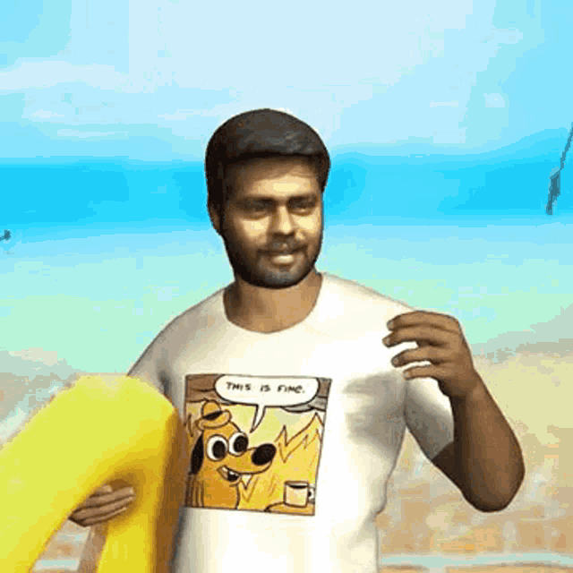 a man wearing a t-shirt with a cartoon dog on it is holding a surfboard on the beach .