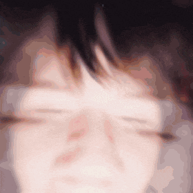 a close up of a person 's face with a blurred background