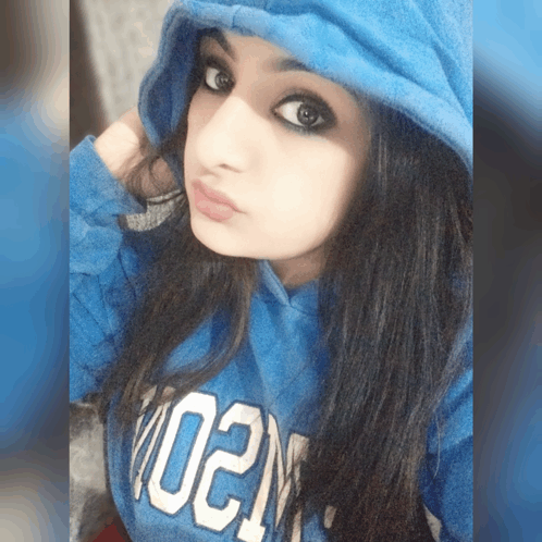 a girl wearing a blue hoodie with the word 02n on it