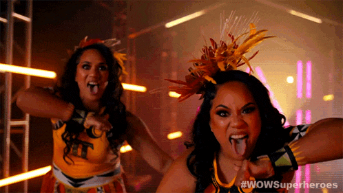 two cheerleaders with their tongues out and #wowsuperheroes written on the bottom right