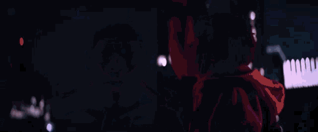 a blurry picture of a person looking up at a city skyline at night