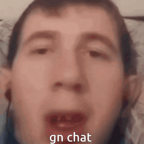 a close up of a man 's face with the words gn chat on the bottom right