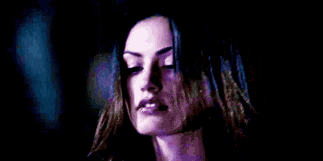 a close up of a woman 's face in the dark .