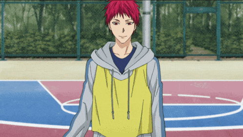 a young man with red hair is standing on a basketball court