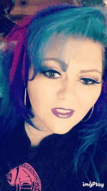 a close up of a woman 's face with the words imgplay on the bottom right