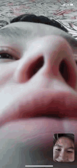 a close up of a person 's face on a phone with lte written on the screen