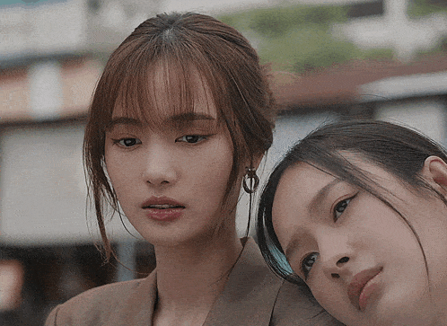 a close up of two women looking at the camera