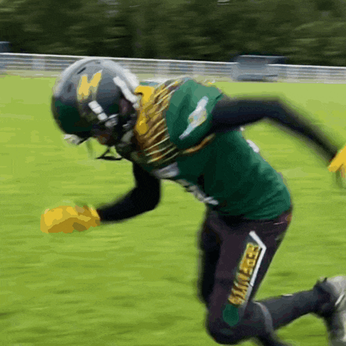 a football player wearing a green jersey that says bulldogs on the bottom