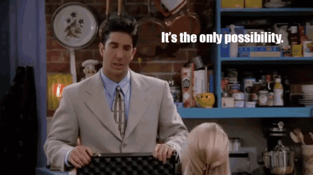 a man in a suit and tie is holding a briefcase and says it 's the only possibility ..