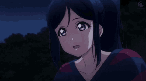 a close up of a girl with a ponytail and purple eyes in a dark room .