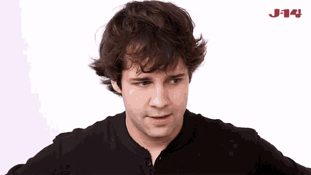 a man in a black shirt with j14 on the bottom