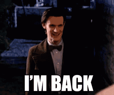 a man in a suit and bow tie says i 'm back in white letters