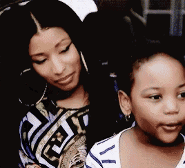 a woman and a little girl are posing for a picture .