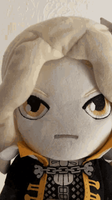 a close up of a stuffed animal with a chain around its mouth