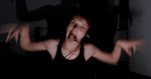 a blurry picture of a person wearing headphones sticking out their tongue