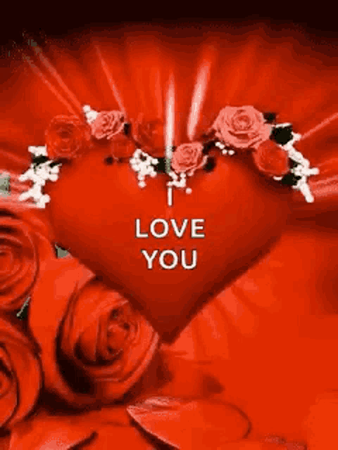 a red heart with roses around it and the words `` i love you '' on it .