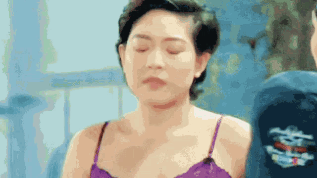 a woman in a purple bra is standing next to a man