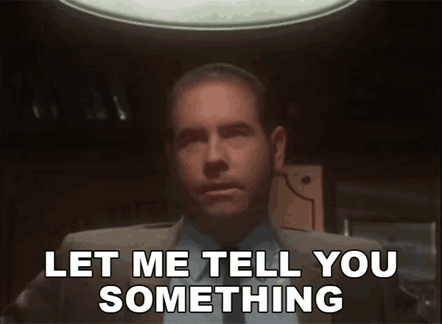 a man in a suit and tie is saying " let me tell you something "