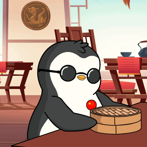 a penguin wearing sunglasses is sitting at a table