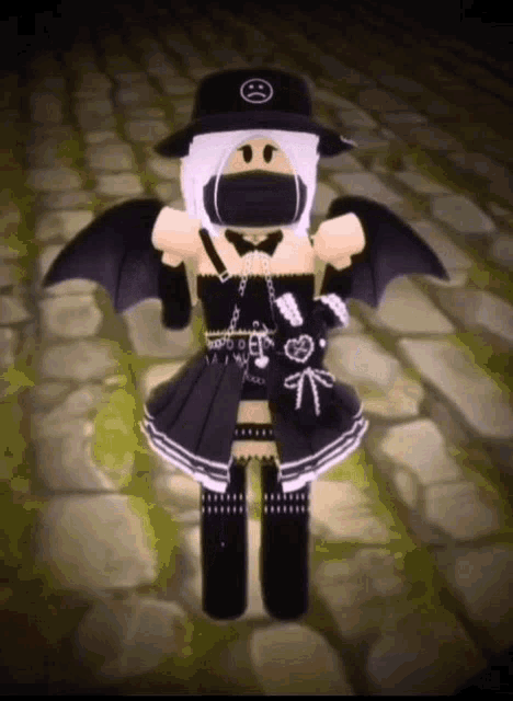 a girl is wearing a black hat and a black dress with wings .