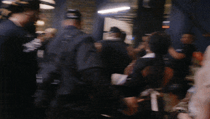 a blurry photo of a crowd of people with the word buzz on the bottom left corner
