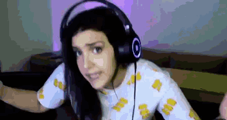 a woman wearing headphones and a shirt that says ' aa ' on it