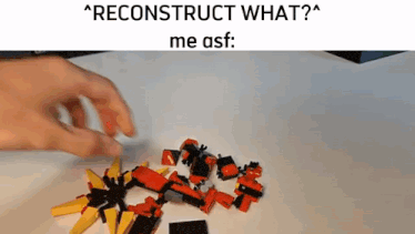 a person is playing with a pile of red and yellow lego pieces on a table .