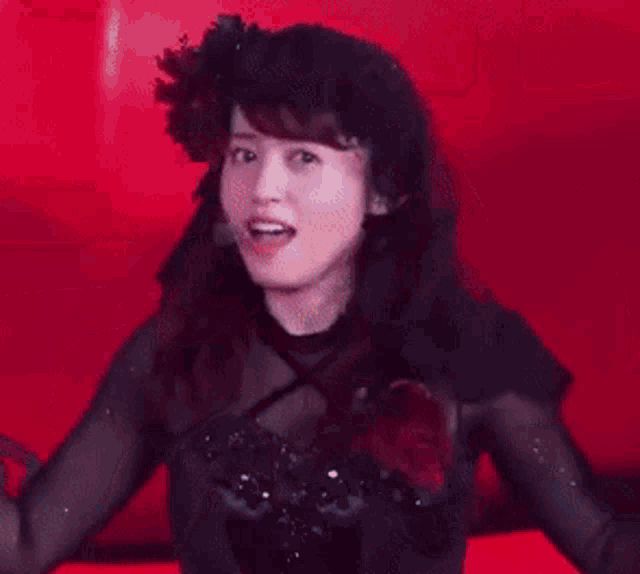 a woman with a microphone in her ear is waving