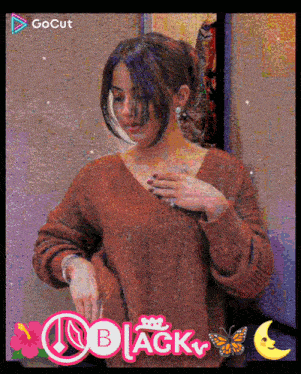a woman in a red sweater with the word black on the bottom