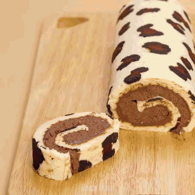 a leopard print cake roll on a cutting board