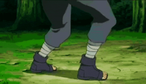a person is standing on a grassy field wearing sandals and bandages on their legs .